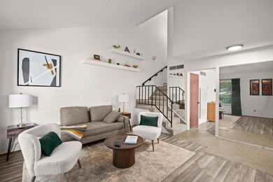 Living area featuring wood finished floors, stair