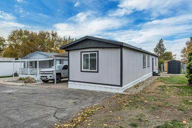 View of property exterior featuring a storage unit and driveway