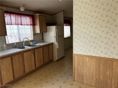 Kitchen with a wainscoted wall, wallpapered walls,