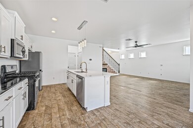 Kitchen featuring light wood-style flooring, stai