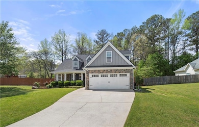 Craftsman-style house featuring stone siding, boar