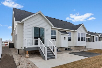 Back of house with a shingled roof