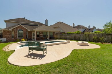 Another view of the pool, the backyard and the very spacious covered patio.  Imagine enjoying time with your family and friends.