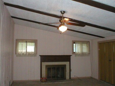 Family Room with vaulted ceiling & woodburning  fi