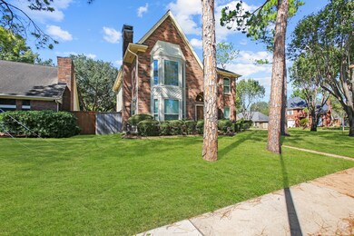 A large yard with mature trees in an established n