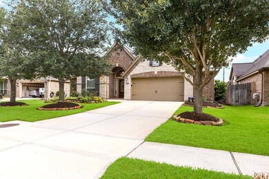 A spacious driveway leads to a two-car garage with a 5-foot extension and an automatic remote door opener. A delightful pathway guides you to the arched entryway and its covered porch at the front door. The driveway space is ample, offering extra front yard play area or guest parking.