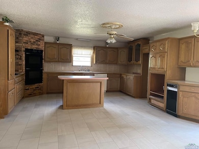 Kitchen with double oven, sink, decorative backspl
