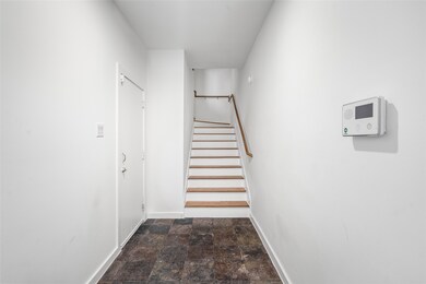 Bright entryway featuring sleek stairs and easy ac