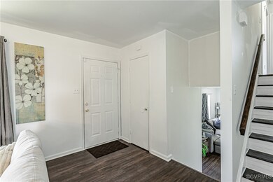 Foyer entrance featuring dark wood-style flooring,