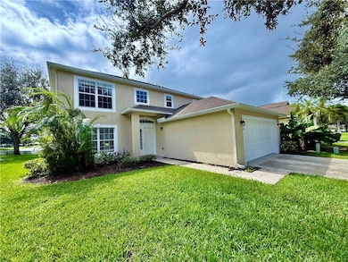 View of front of property with concrete driveway, a front yard, stucco siding, a garage, and roof with shingles