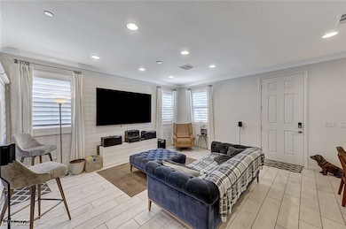 Living area with wood tiled floor, ornamental mold