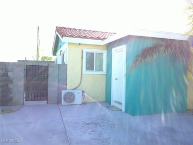 View of side of property featuring ac unit, a tile