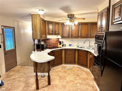 Kitchen with backsplash, light countertops, black 