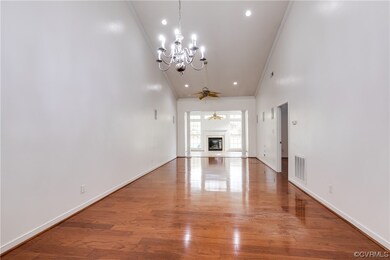 Unfurnished living room featuring ornamental moldi