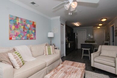 Living room with ornamental molding, dark wood-sty