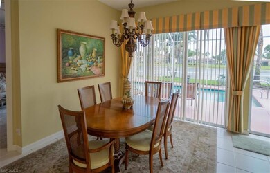 Dining space with an inviting chandelier, tile pat