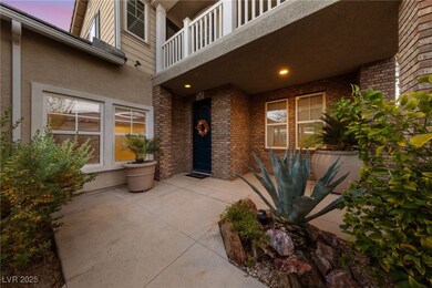 Exterior entry at dusk featuring a balcony, brick