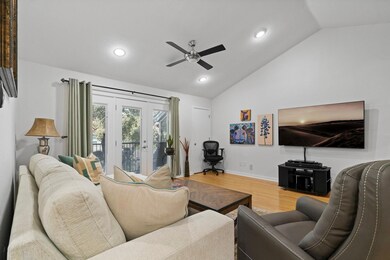 Living room with ceiling fan, wood finished floor