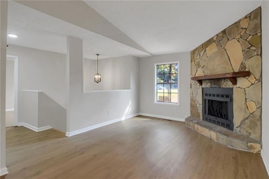 Unfurnished living room featuring wood finished floors and a fireplace