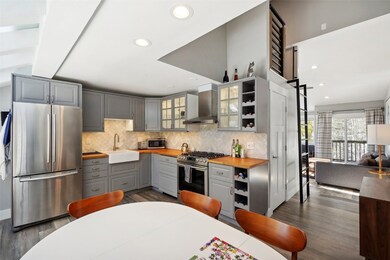 Kitchen featuring a sink, wood counters, appliance