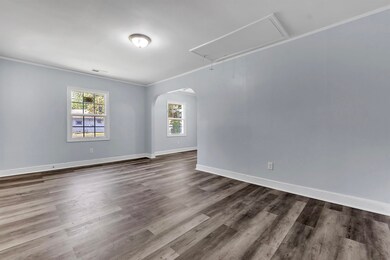 Spare room with baseboards, visible vents, ornamen