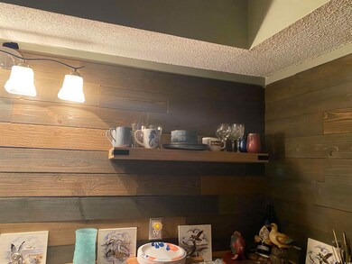 Interior details with wood walls and a textured ce