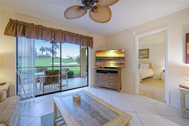 Living room featuring ceiling fan and light tile p