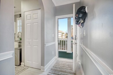 Entryway with sink, light tile patterned floors, a