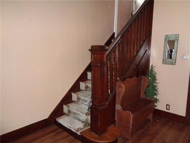 Original wood staircase and stairs leading to seco