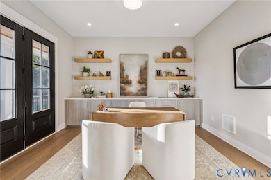 Bar area featuring open shelves, french doors, light wood-type flooring, light countertops, and recessed lighting