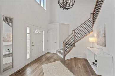 The custom staircase serves as a striking centerpi