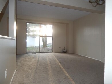 The open concept living room and dining room is great for entertaining. Patio doors let in loads of natural light and open to a concrete patio.