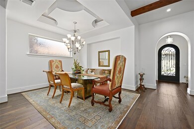 Dining area with a chandelier, arched walkways, d