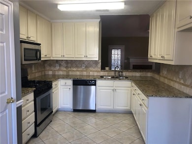 Kitchen featuring light tile patterned flooring, a