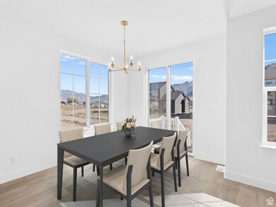 Dining area featuring light wood-style floors, a mountain view, and a chandelier