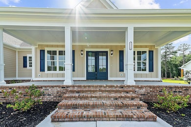 Property entrance featuring board and batten siding and covered porch