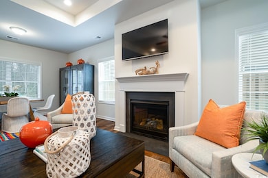 Living area with a fireplace with flush hearth, ba