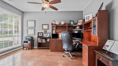 This home office features a spacious layout with l