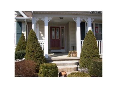 Front door and porch inviting entrance-way to your