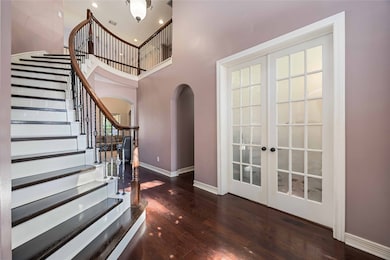 Beyond these inviting glass panes lies the next chapter. The curving banister beckons you toward the next level of your dreams. A moment captured in the entryway, symbolizing the beautiful balance between solid foundation and soaring potential.