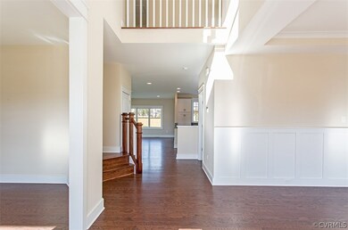 Two story foyer creates a grand entrance to a dini