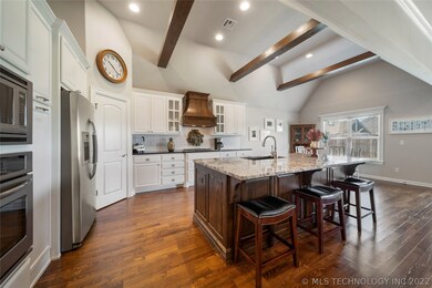 Open kitchen features rich hardwoods & subway tile
