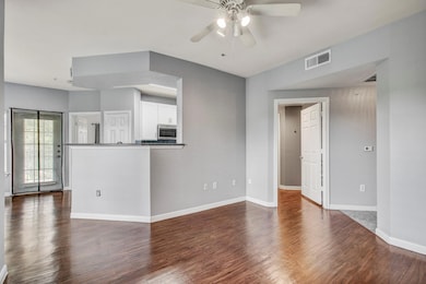 Unfurnished living room featuring a ceiling fan a