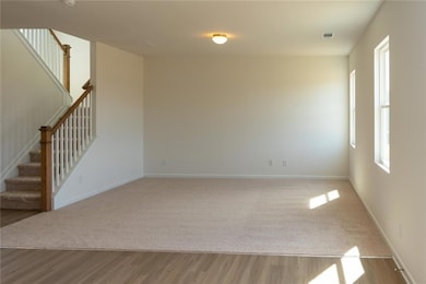 Spare room with visible vents, wood finished floor