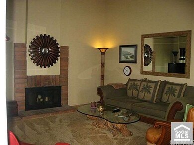 Offset living room with fireplace and 2 story vaul