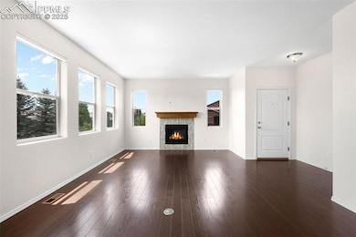 Living area featuring wood finished floors and a gas fireplace