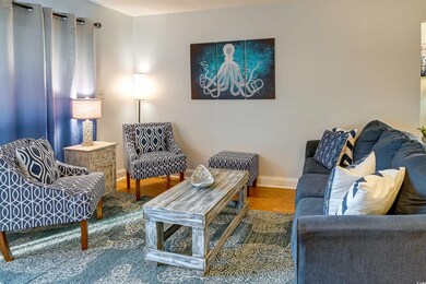 Living room featuring baseboards and wood finished floors