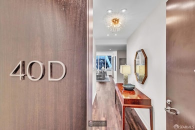 An elegant corridor welcomes you into the residence, where custom details and rich flooring guide you toward light-filled living spaces.