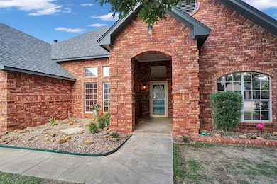 Entrance to property featuring roof with shingles and brick siding