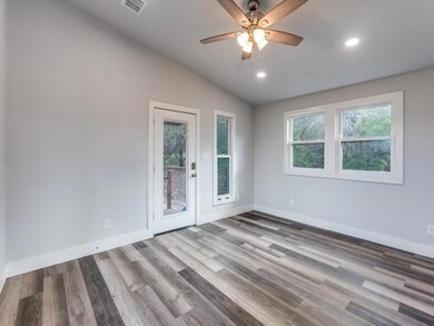 Empty room featuring lofted ceiling, wood finishe